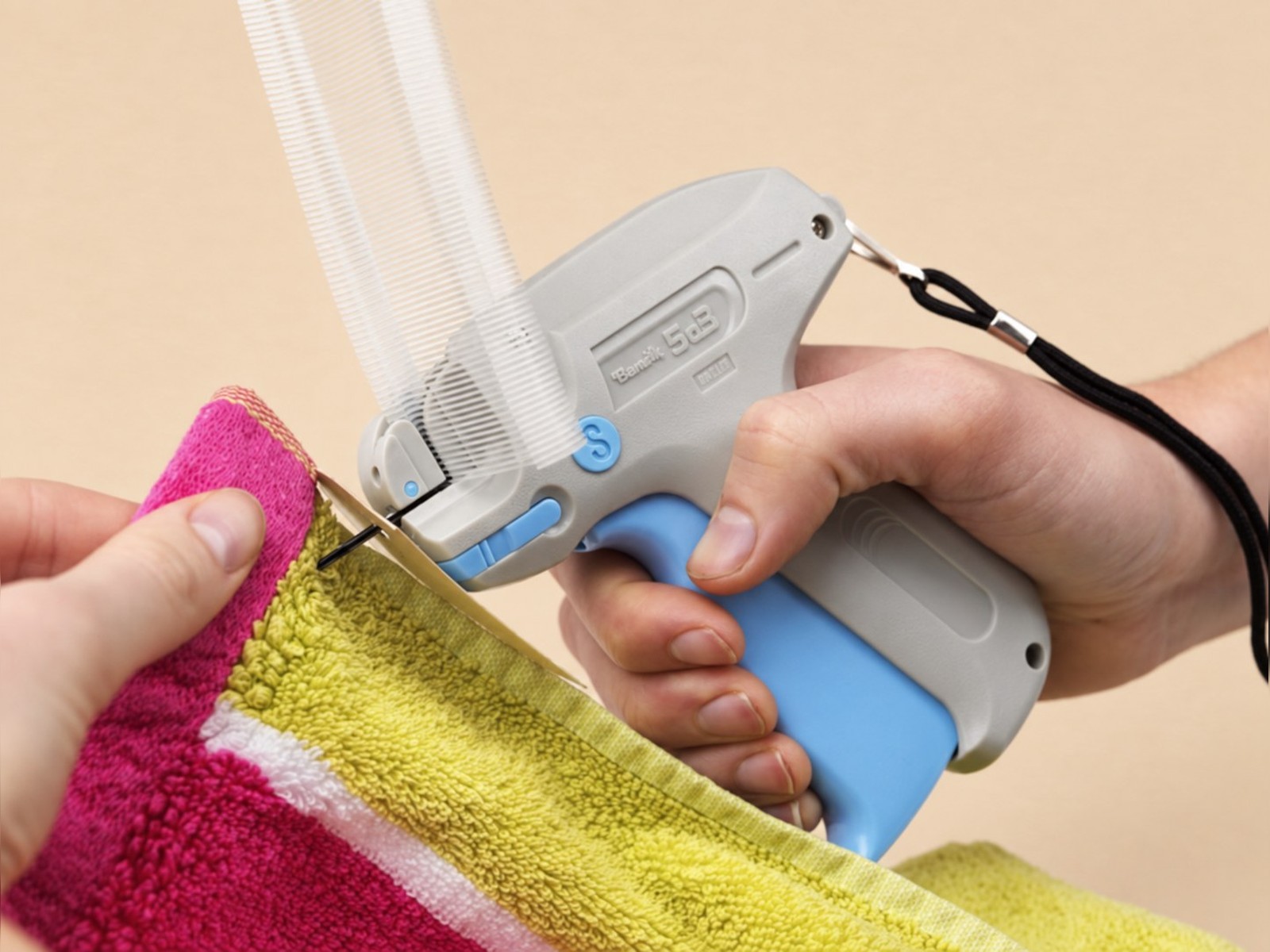 Professional Tagging Gun in use on a towel